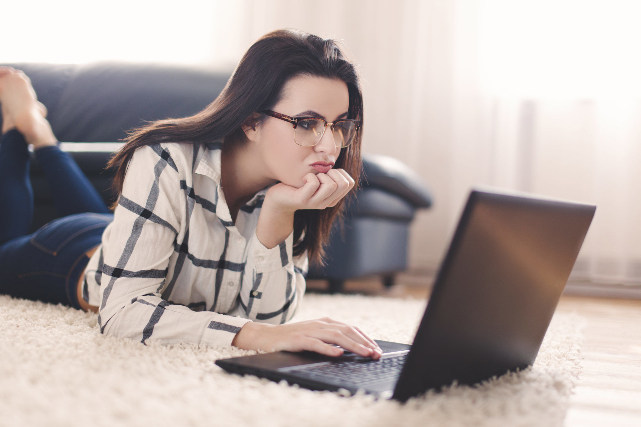 Woman searching for boys online on laptop indoor