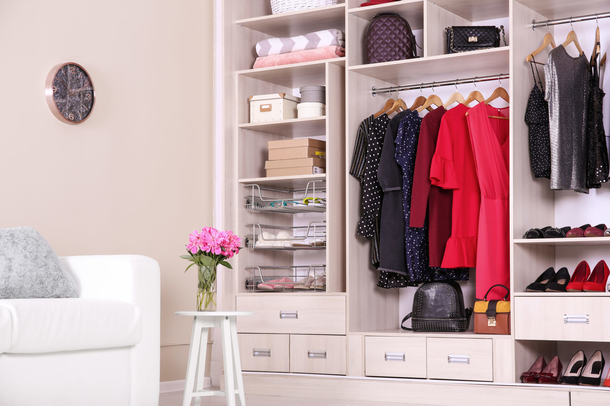 Modern wardrobe with stylish clothes in room interior